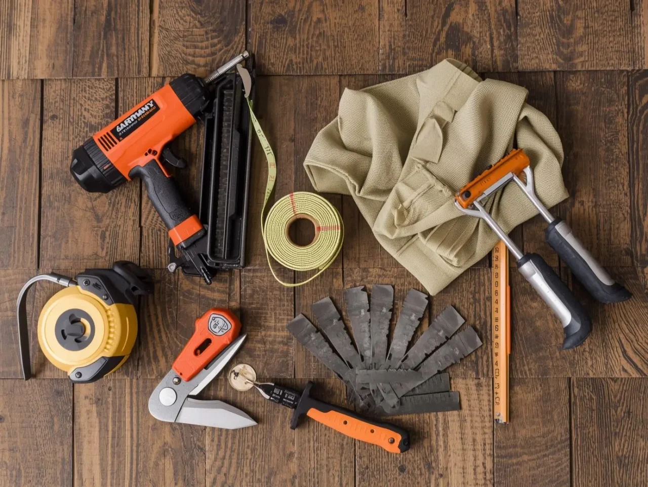 Complete DIY roof installation tool kit showing essential equipment for installing wood shake shingles including nailer and measuring tools