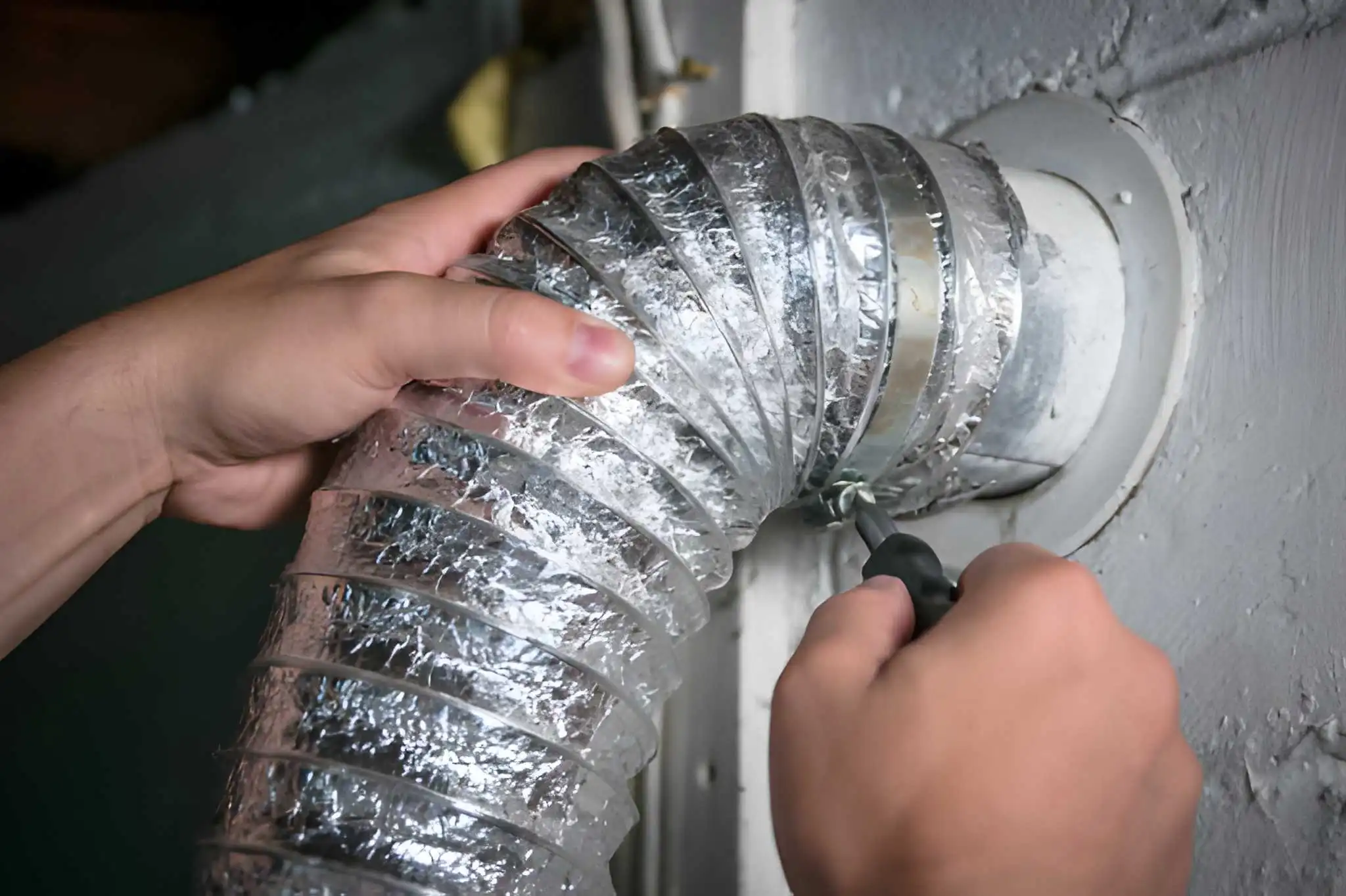 Dryer vent installation through roof - Roofer installing dryer-specific vent cap with aluminum flashing on asphalt shingle roof - Roof Installation