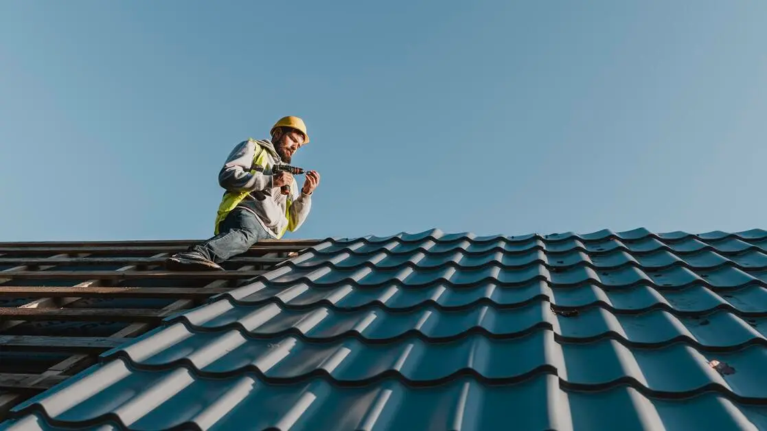 Tin roof installation - Professional installer fastening standing seam metal panels on residential home roof with chalk line alignment - Roof Installation