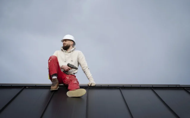 Residential roof repairs, roofing contractor inspecting damaged asphalt shingles on a suburban home roof showing curling edges and granule loss, repair vs replacement 2026