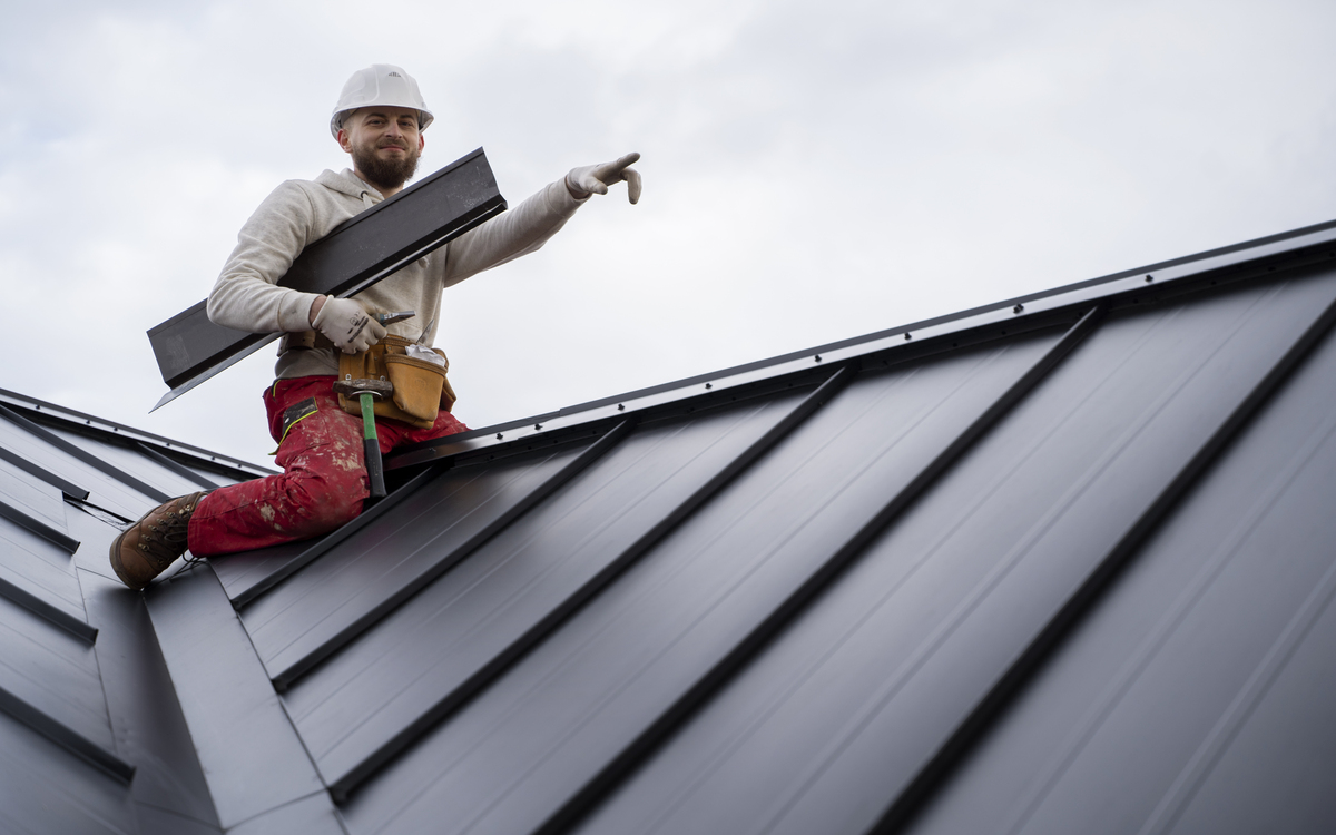 Residential roof repair vs replacement decision, homeowner reviewing two contractor written quotes on clipboard comparing repair and replacement costs at kitchen table, roof repair 2026