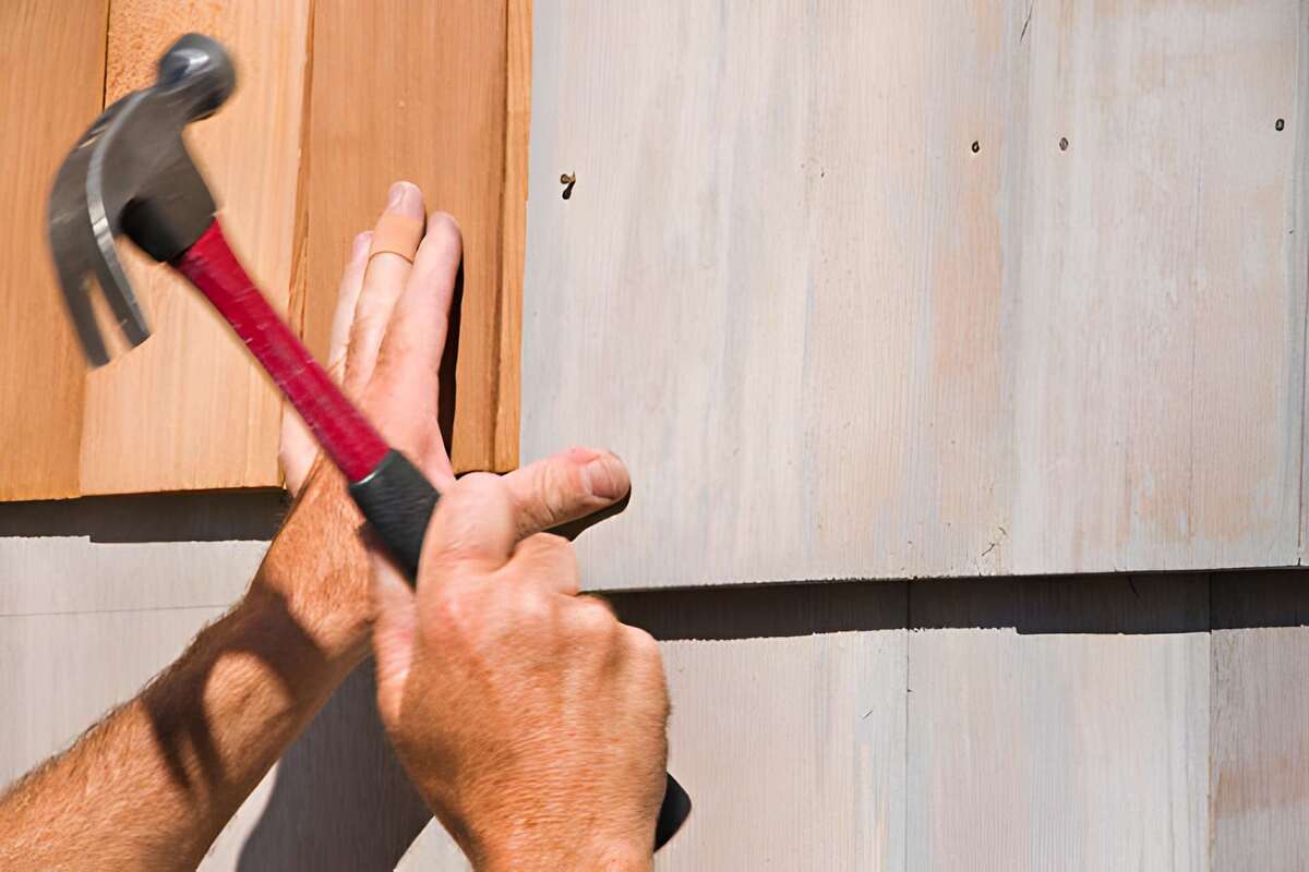 Professional roofers installing cedar shake shingles to show cost factors