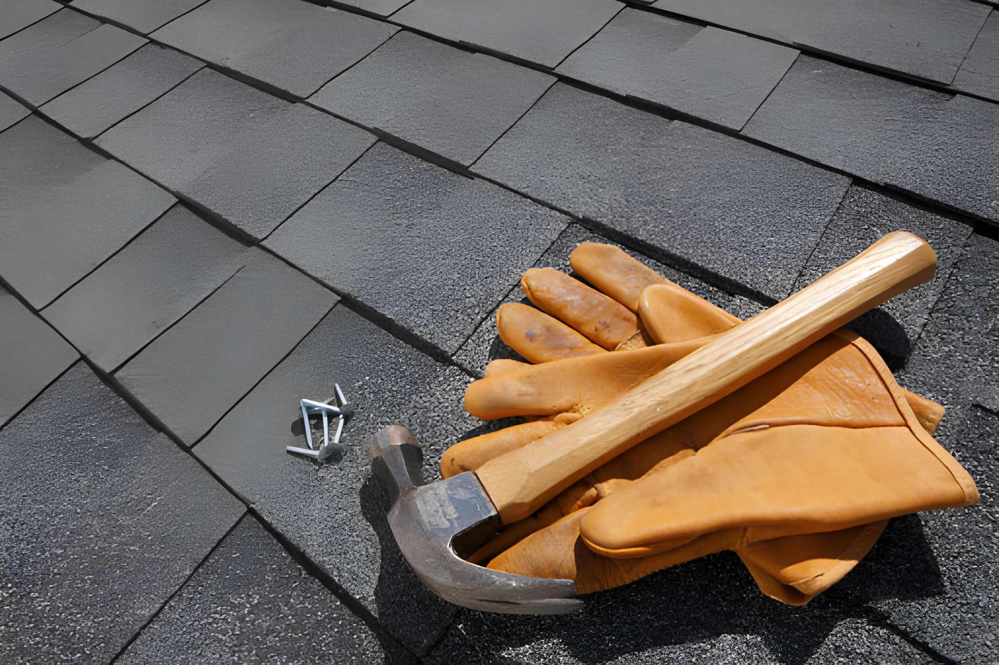 Roofing hammer with hatchet blade and magnetic nail holder resting on cedar shingles